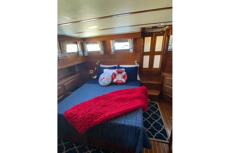 Slide: The Image of Cozy cabin interior of 2000 Sabreline 47 yacht with nautical decor and wooden finishes. - 27