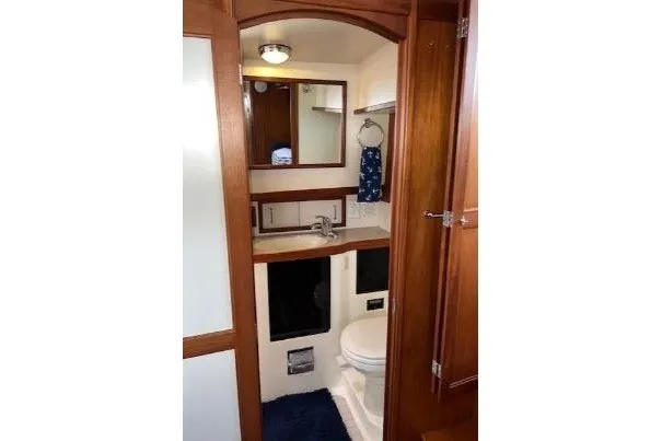 Slide: The Image of Bathroom interior of 2000 Sabreline 47 yacht with wooden cabinetry and modern fixtures. - 29