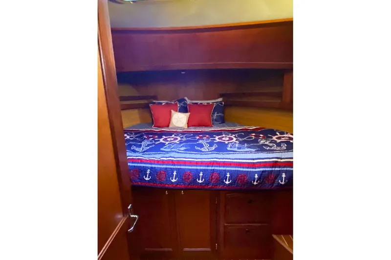 Slide: The Image of Cozy cabin interior of 2000 Sabreline 47 yacht with nautical-themed bedding. - 33