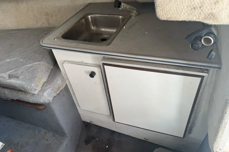 Slide: The Image of Interior of 1995 Bayliner 2302 Trophy Walkaround with sink and storage cabinet. - 18