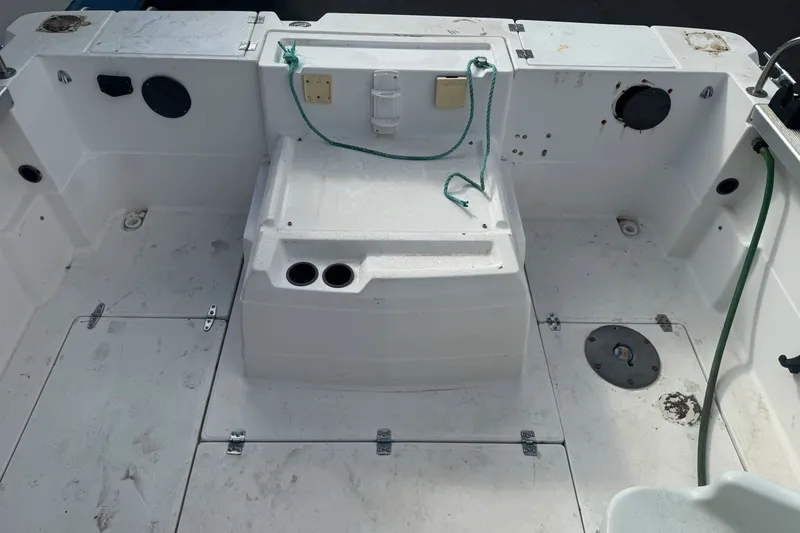 Slide: The Image of 1995 Bayliner 2302 Trophy Walkaround boat deck with storage compartments and fishing rod holders. - 8