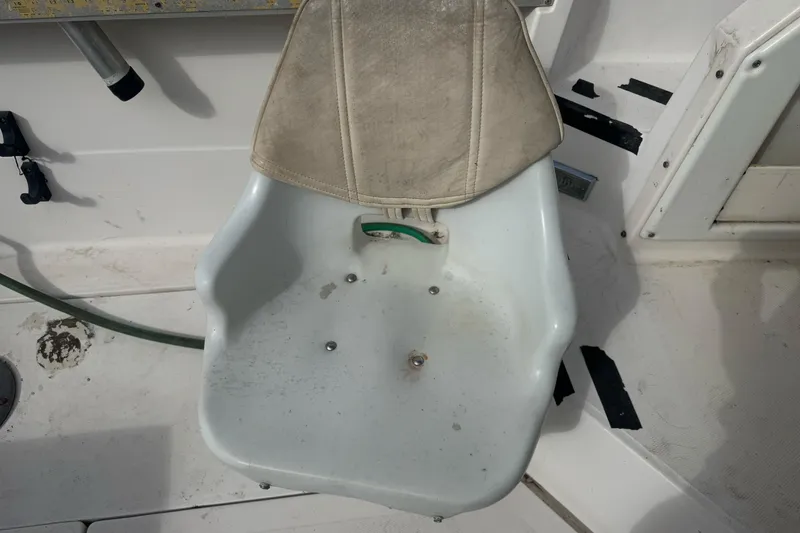 Slide: The Image of Boat seat on a 1995 Bayliner 2302 Trophy Walkaround, showing wear and marine environment. - 10
