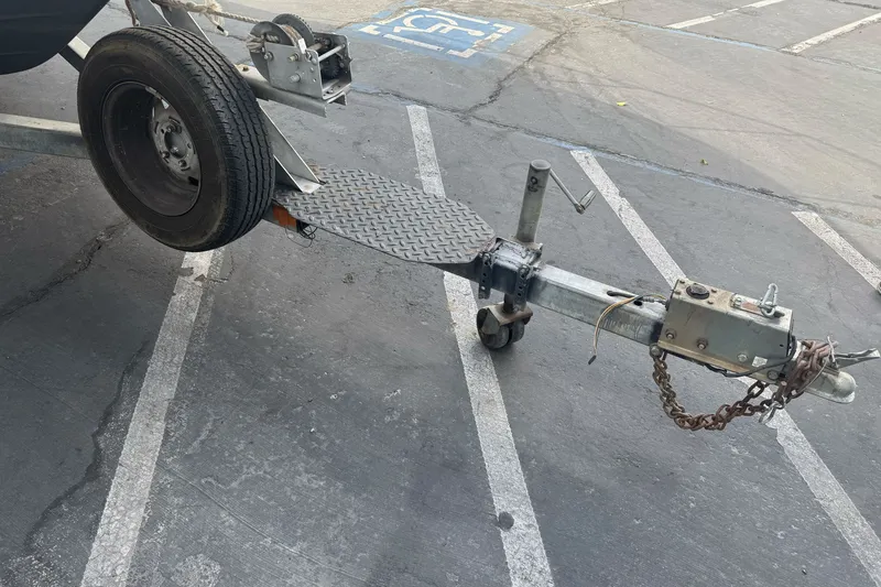 Slide: The Image of Trailer hitch of a 1995 Bayliner 2302 Trophy Walkaround in a parking lot. - 2