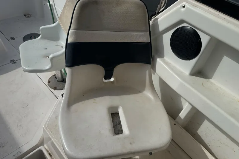 Slide: The Image of 1995 Bayliner 2302 Trophy Walkaround boat seat with speaker, showcasing interior details. - 12