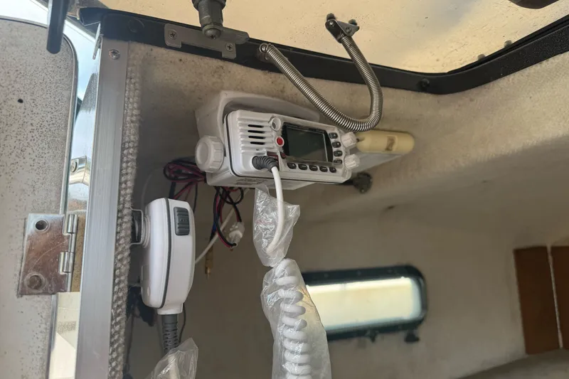 Slide: The Image of Interior of a 1995 Bayliner 2302 Trophy Walkaround with mounted marine radio equipment. - 21