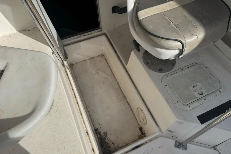 Slide: The Image of 1995 Bayliner 2302 Trophy Walkaround boat interior with seat and storage compartments. - 14