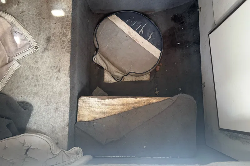 Slide: The Image of Interior of a 1995 Bayliner 2302 Trophy Walkaround boat showing storage compartment. - 20