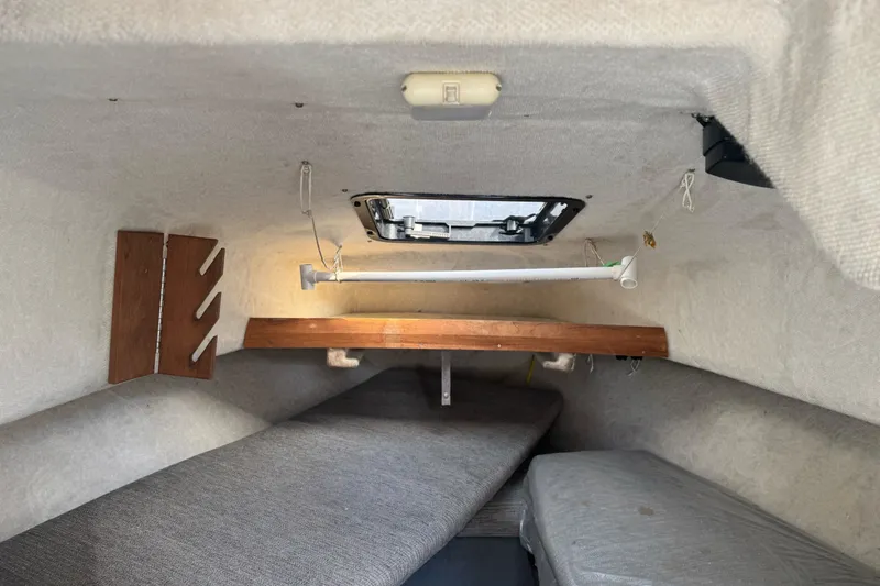 Slide: The Image of Interior cabin of 1995 Bayliner 2302 Trophy Walkaround boat, featuring cozy sleeping area. - 17