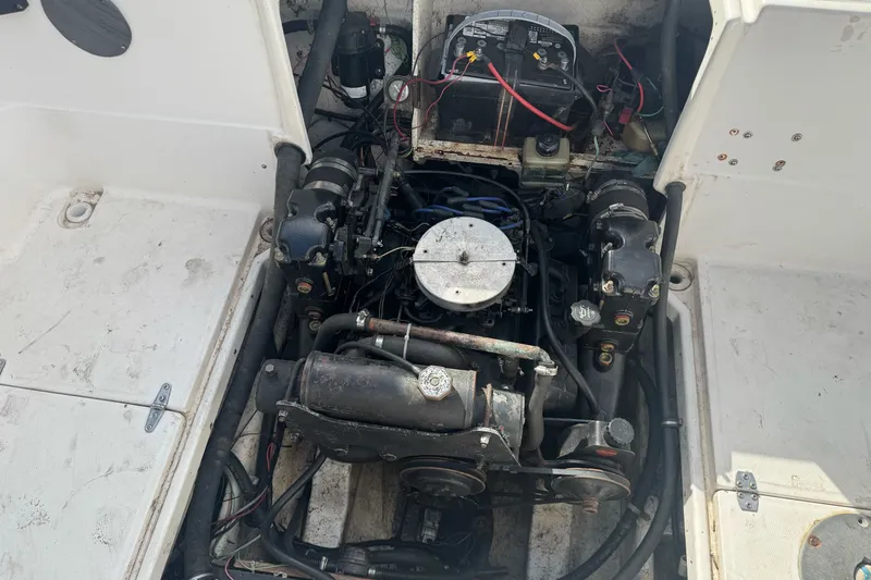 Slide: The Image of Engine compartment of a 1995 Bayliner 2302 Trophy Walkaround boat, showing detailed components. - 24