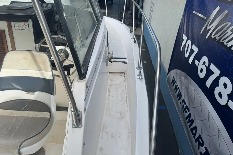 Slide: The Image of 1995 Bayliner 2302 Trophy Walkaround boat interior with steering wheel and seat. - 26