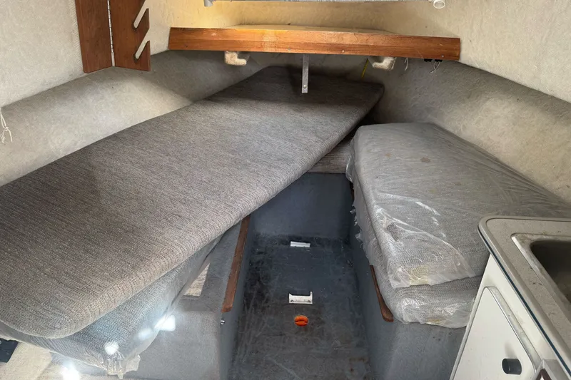 Slide: The Image of Interior cabin of 1995 Bayliner 2302 Trophy Walkaround boat with cushioned seating. - 16