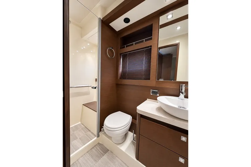 Slide: The Image of Luxurious bathroom interior of 2014 Sea Ray 510 Fly yacht, featuring modern fixtures and wood accents. - 28