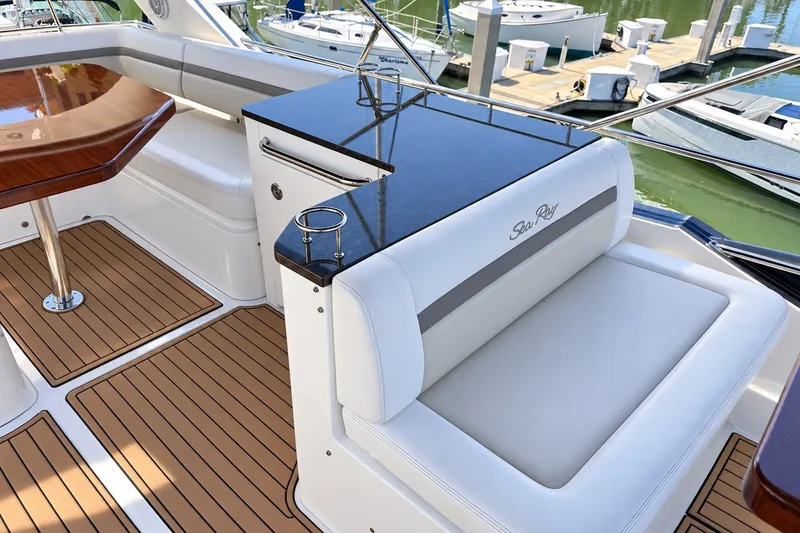 Slide: The Image of Luxurious 2014 Sea Ray 510 Fly yacht interior with elegant seating and polished wood table. - 39