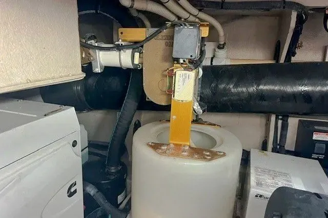 Slide: The Image of Engine room of 2014 Sea Ray 510 Fly yacht, featuring mechanical components and piping. - 51