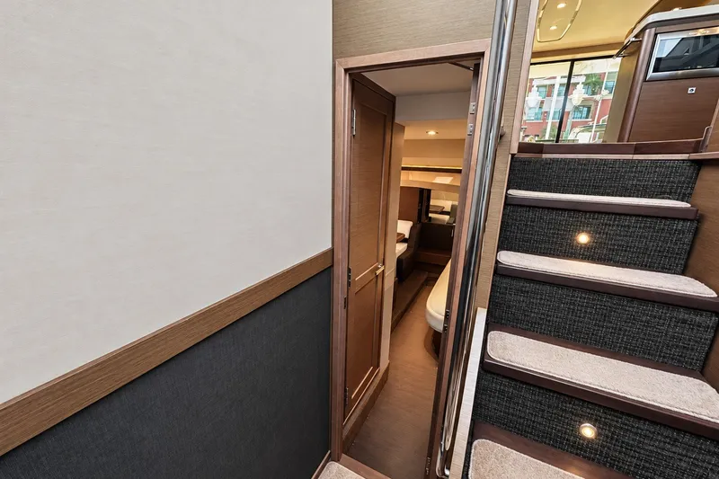 Slide: The Image of Interior view of 2014 Sea Ray 510 Fly yacht, featuring stairs and a cozy cabin. - 23