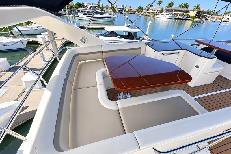 Slide: The Image of Luxurious 2014 Sea Ray 510 Fly yacht with elegant seating and polished wood table. - 38