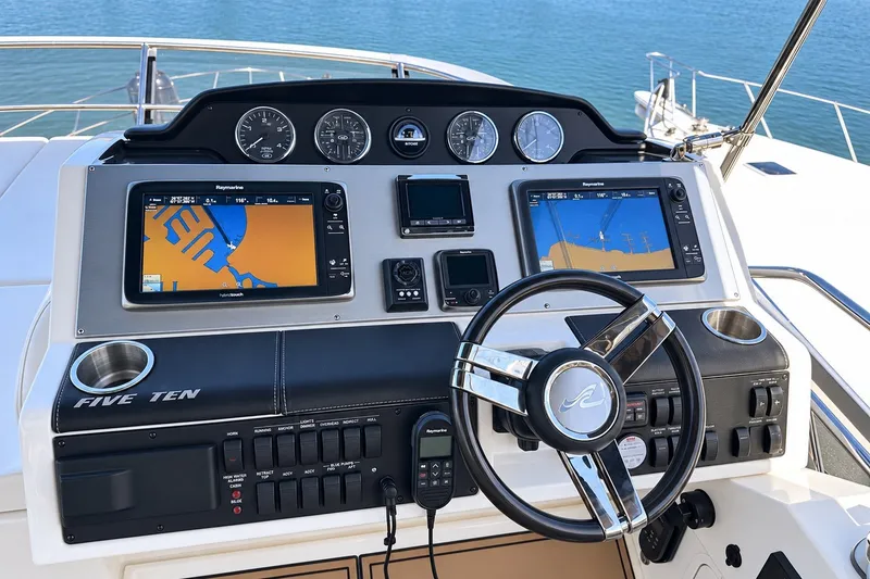 Slide: The Image of Helm of 2014 Sea Ray 510 Fly yacht with navigation screens and controls. - 42