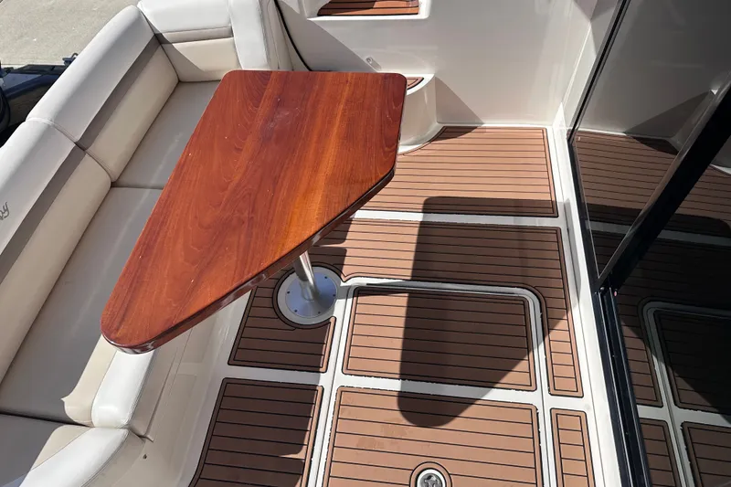 Slide: The Image of Luxurious 2014 Sea Ray 510 Fly yacht deck with elegant wood table and seating. - 47