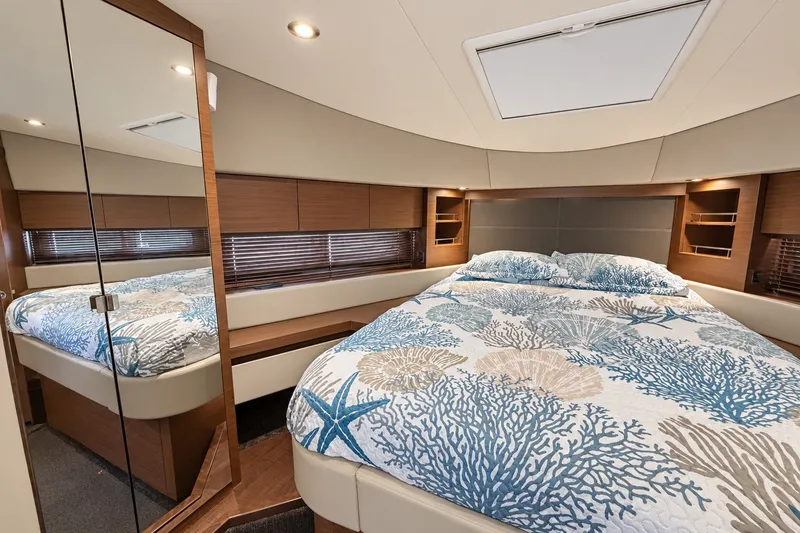 Slide: The Image of Luxurious bedroom interior of 2014 Sea Ray 510 Fly yacht with nautical-themed bedding. - 31
