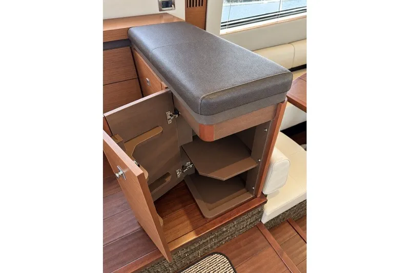 Slide: The Image of Interior storage compartment on 2014 Sea Ray 510 Fly yacht with open wooden cabinet. - 10