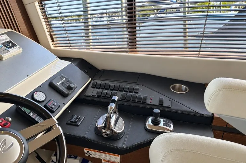 Slide: The Image of Control panel of a 2014 Sea Ray 510 Fly yacht with steering and navigation equipment. - 18