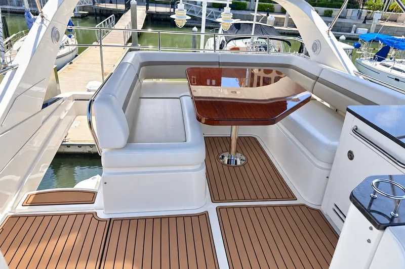 Slide: The Image of Luxurious seating area on 2014 Sea Ray 510 Fly yacht with wooden table and marina view. - 45