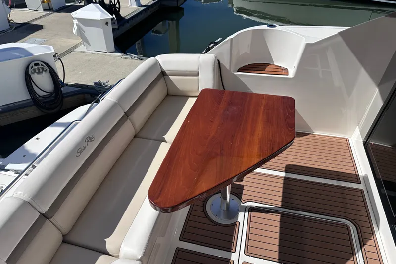 Slide: The Image of Luxurious 2014 Sea Ray 510 Fly yacht with elegant seating and wooden table on deck. - 46