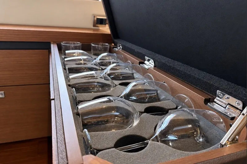 Slide: The Image of Wine glasses stored in a wooden cabinet on a 2014 Sea Ray 510 Fly yacht. - 12