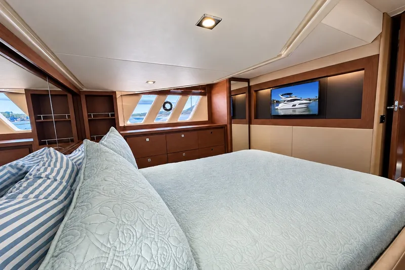 Slide: The Image of Luxurious 2014 Sea Ray 510 Fly yacht bedroom with elegant bedding and scenic windows. - 26