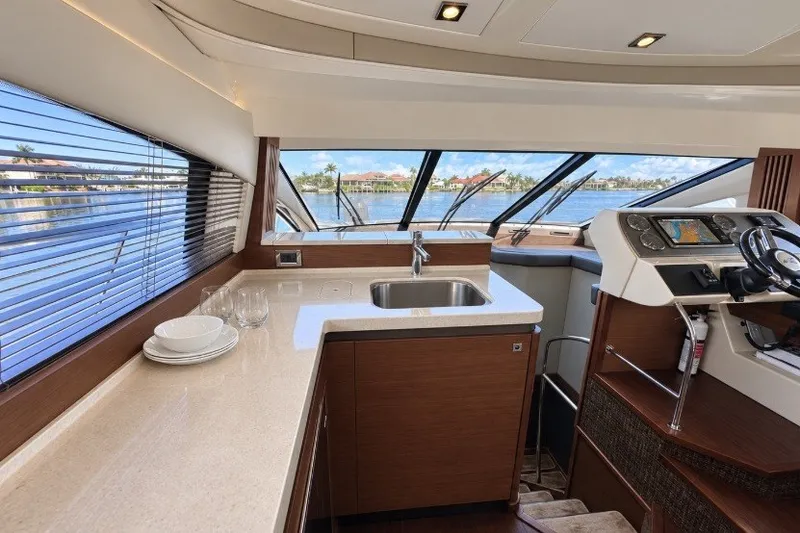 Slide: The Image of Luxurious interior of 2014 Sea Ray 510 Fly yacht with modern kitchen and helm. - 8