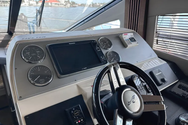 Slide: The Image of Cockpit of 2014 Sea Ray 510 Fly yacht with steering wheel and navigation instruments. - 17