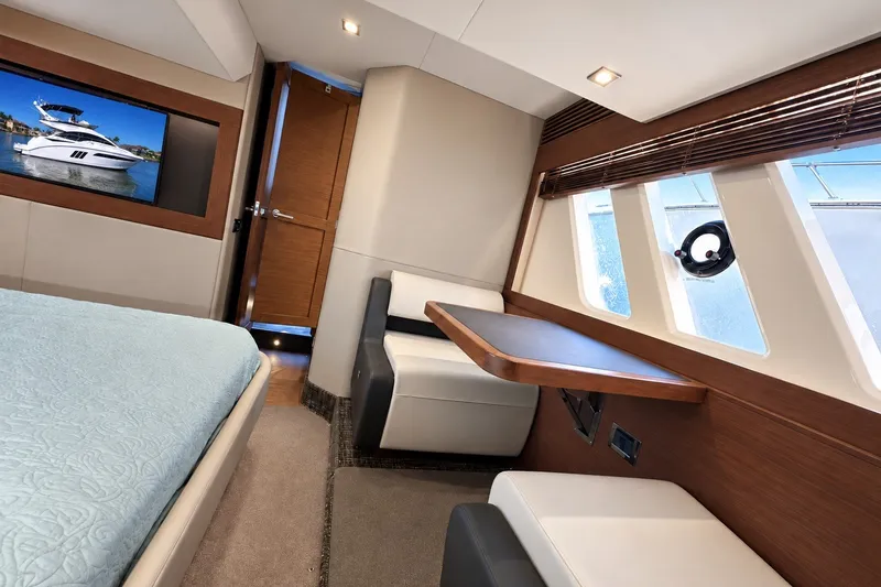 Slide: The Image of Luxurious interior of 2014 Sea Ray 510 Fly yacht with modern furnishings and large windows. - 27