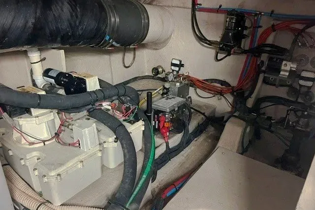 Slide: The Image of Engine room of a 2014 Sea Ray 510 Fly yacht, showcasing mechanical components and wiring. - 56