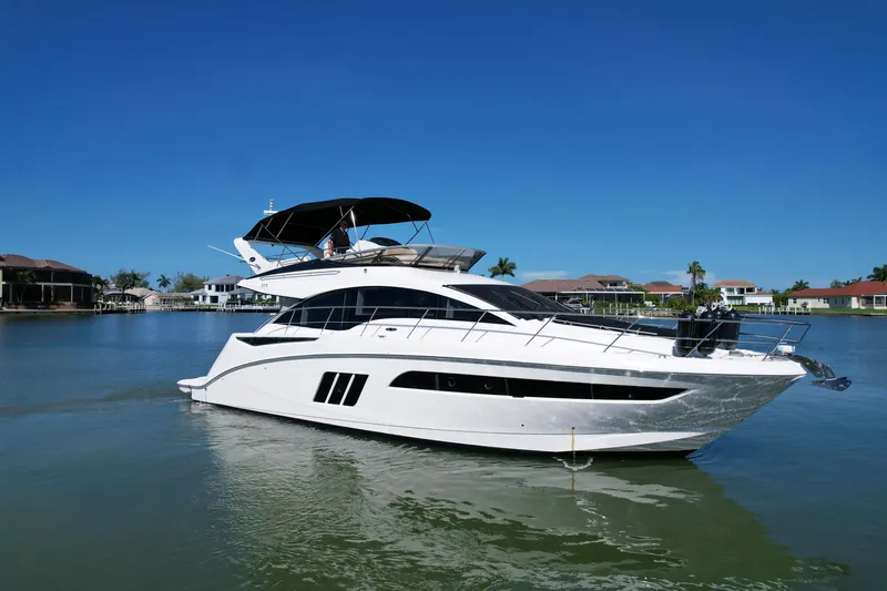 Slide: The Image of 2014 Sea Ray 510 Fly yacht on calm water under clear blue sky. - 2