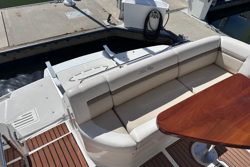 Slide: The Image of Luxurious seating area on a 2014 Sea Ray 510 Fly yacht with wooden table. - 48