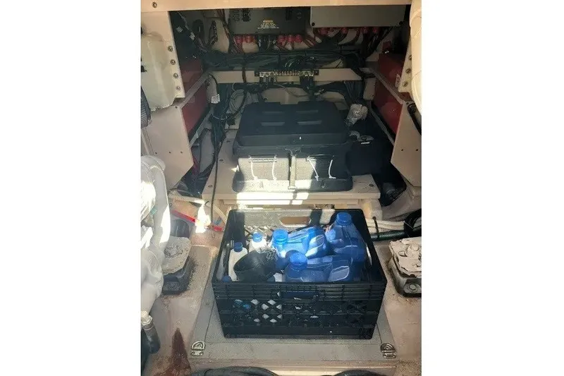 Slide: The Image of Engine compartment of a 2014 Sea Ray 510 Fly with storage crate and equipment. - 50