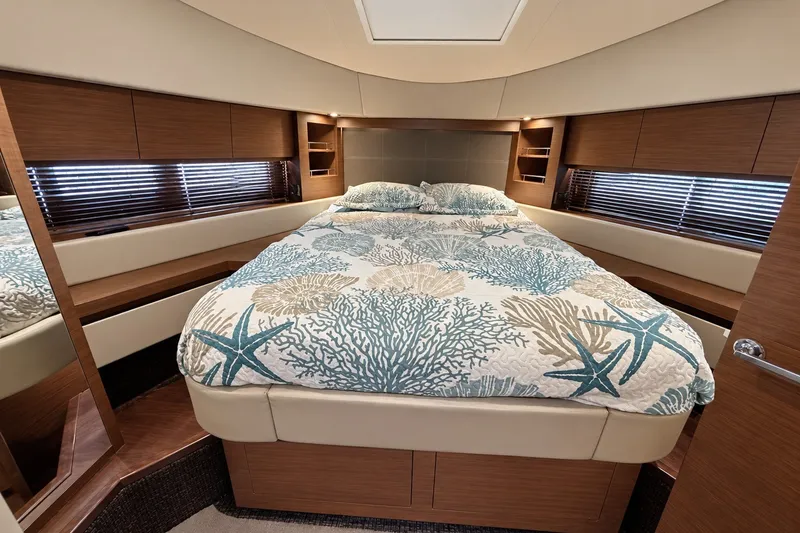 Slide: The Image of Luxurious 2014 Sea Ray 510 Fly yacht bedroom with elegant bedding and wood accents. - 30