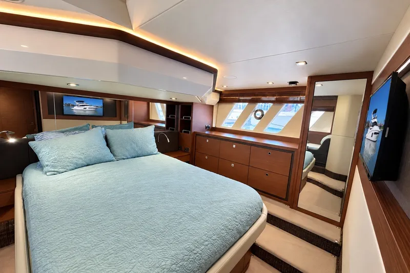 Slide: The Image of Luxurious 2014 Sea Ray 510 Fly yacht bedroom with elegant wood finishes and modern amenities. - 25