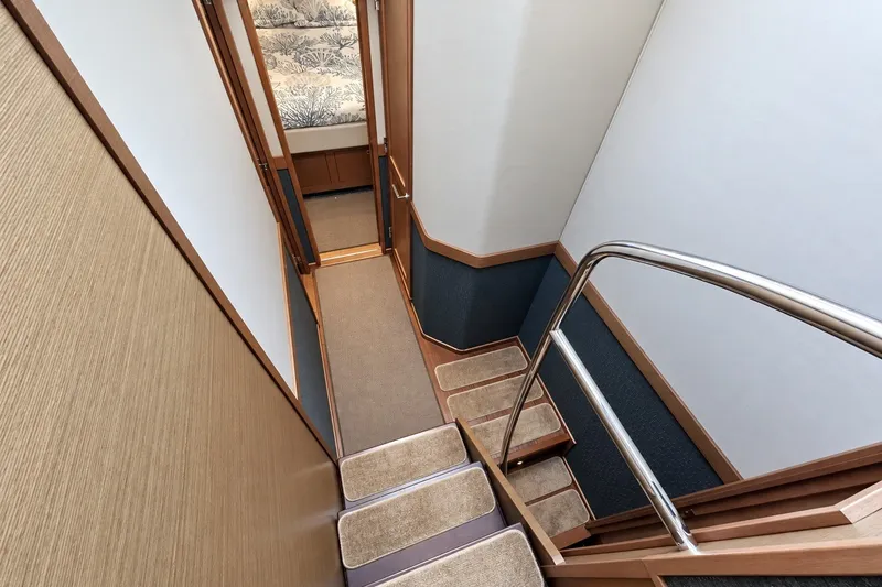Slide: The Image of Interior staircase of 2014 Sea Ray 510 Fly yacht, featuring wooden steps and modern design. - 22