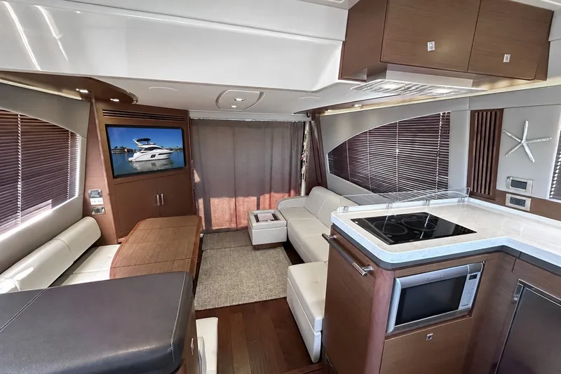 Slide: The Image of Luxurious interior of 2014 Sea Ray 510 Fly yacht with modern kitchen and seating area. - 4