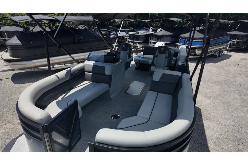 Slide: The Image of 2027 Viaggio x20u pontoon boat with spacious seating and modern design in a marina setting. - 17