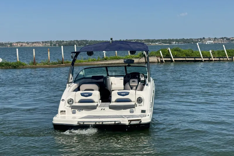 Slide: The Image of 2020 Chaparral Vortex 223 VRX boat on water, with scenic shoreline background. - 7