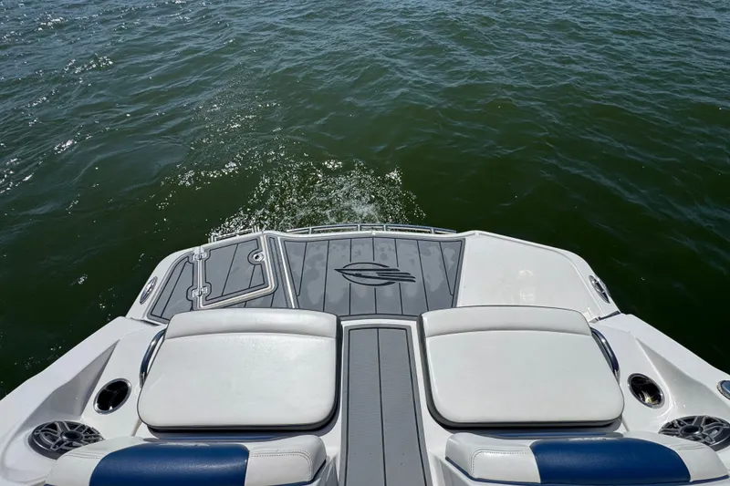 Slide: The Image of 2020 Chaparral Vortex 223 VRX boat deck on water, featuring sleek design and comfortable seating. - 24