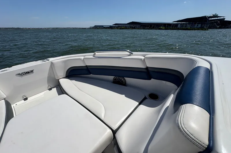 Slide: The Image of 2020 Chaparral Vortex 223 VRX boat interior with blue and white seating on a sunny day. - 11