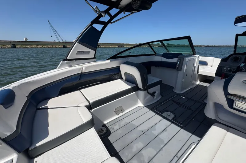 Slide: The Image of 2020 Chaparral Vortex 223 VRX boat interior with sleek seating and modern design on the water. - 26