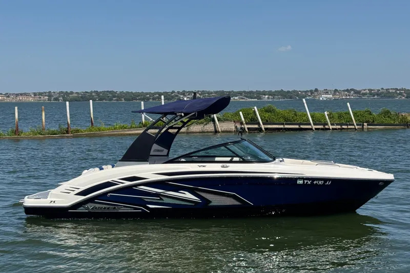 Slide: The Image of 2020 Chaparral Vortex 223 VRX boat on a serene lake with clear skies. - 5
