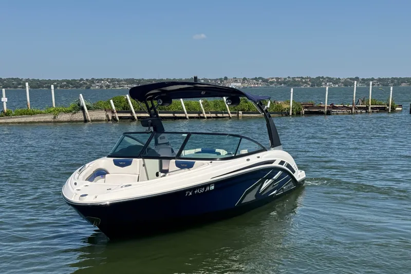 Slide: The Image of 2020 Chaparral Vortex 223 VRX boat on a calm lake near a dock. - 2