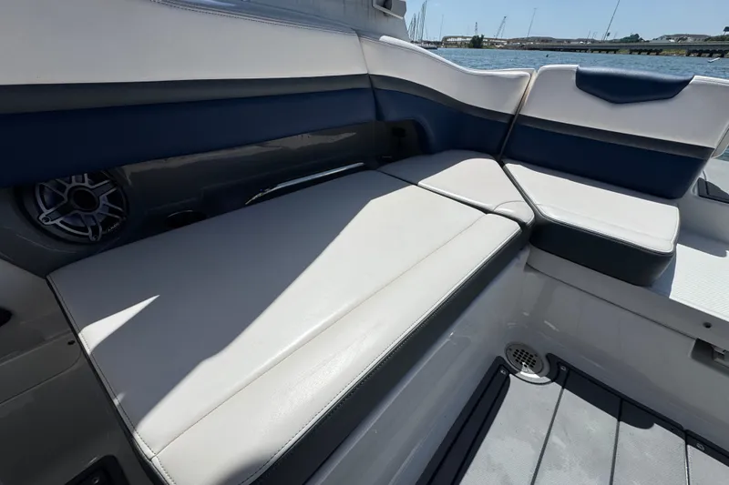 Slide: The Image of 2020 Chaparral Vortex 223 VRX boat interior with cushioned seating and speaker. - 20