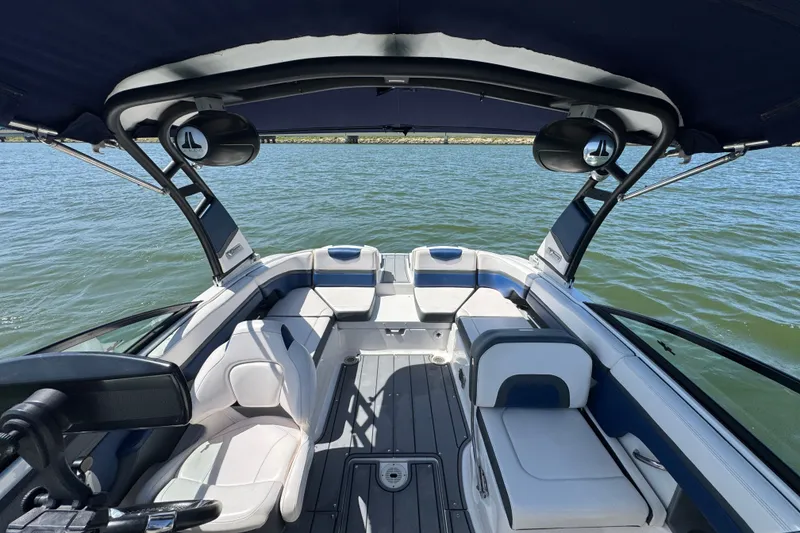 Slide: The Image of 2020 Chaparral Vortex 223 VRX boat interior with seating, on a calm lake. - 12