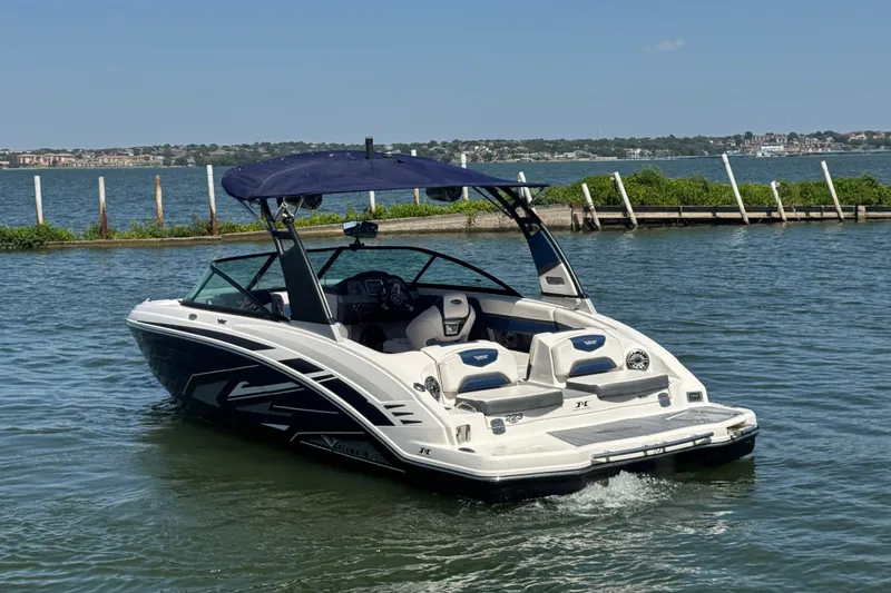 Slide: The Image of 2020 Chaparral Vortex 223 VRX boat on water with blue canopy, scenic background. - 8